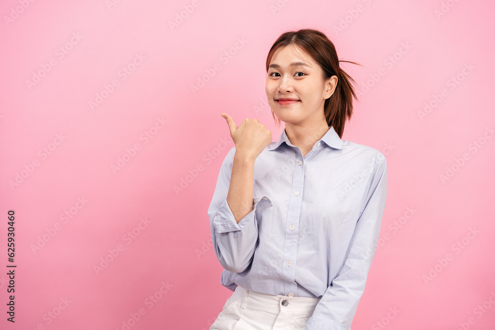 Young asian woman wearing long sleeve shirt while using hand with fingers to doing one thumb up and pointing Young asian woman wearing long sleeve shirt while using hand with fingers to doing one thumb up and pointing