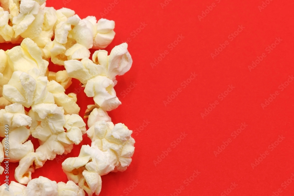 Some popcorn on red background