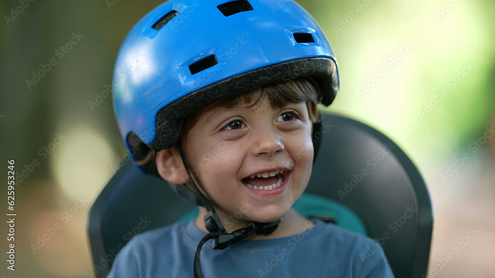 Happy little boy wearing bicycle helmet laughing and smiling Happy little boy wearing bicycle helmet laughing and smiling