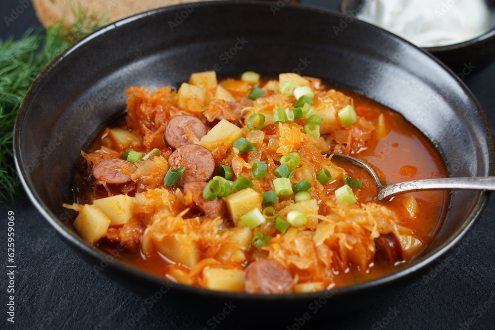 Czech cabbage soup Zelnacka or Bohemian cabbage soup with potatoes, smoked bacon, sausages and vegetables Czech cabbage soup Zelnacka or Bohemian cabbage soup with potatoes, smoked bacon, sausages and vegetables