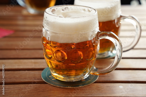 Czech-style Pilsner lager golden beer on table of bar pub restaurant in Prague, Czech Republic.