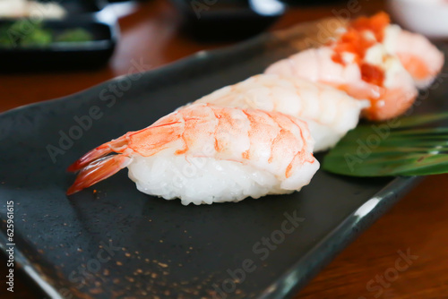 sushi or shrimp sushi or shrimp rolls, rice topped with shrimp or prawn rolls and salmon rolls photo