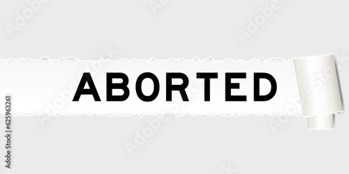 Ripped gray paper background that have word aborted under torn part