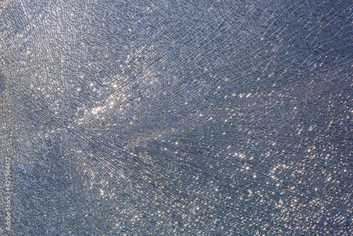 cracks at tempered glass, spoiled glass surface, texture background, blind windscreen close-up, nobody.