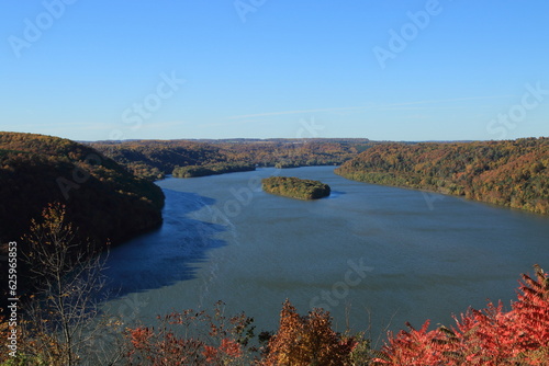 Landscape of river with forested riverside and a small island