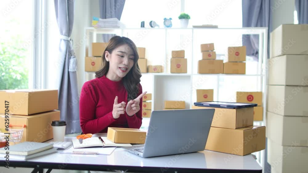 Young Asian woman working at home small business doing live broadcast talking sales to customers on internet. Young Asian woman working at home small business doing live broadcast talking sales to customers on internet.