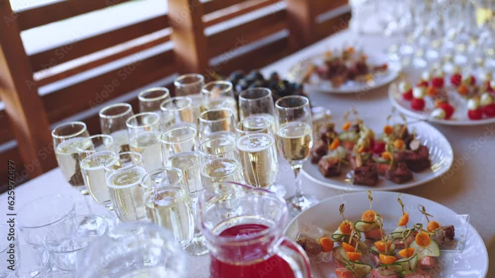 Champagne at the buffet, glasses of champagne on the buffet table, glasses of champagne with snacks Champagne at the buffet, glasses of champagne on the buffet table, glasses of champagne with snacks