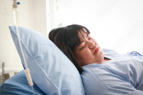 Fat woman lying on a hospital bed. Obesity, diabetes, high blood pressure, health problems. Getting health insurance