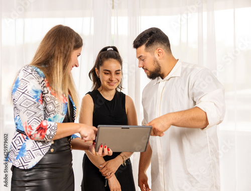 Team working together looking at a tablet