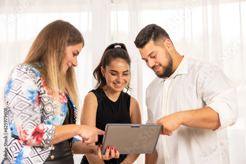 Team working together looking at a tablet