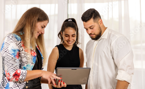 Team working together looking at a tablet