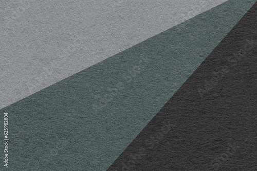 Texture of old craft gray , green and black color paper background, macro. Vintage abstract teal cardboard