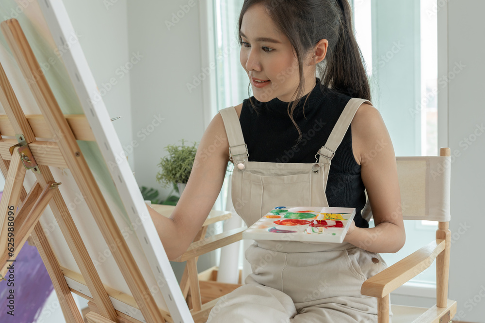 beautiful female hobbies about artist and use paintbrush in abstract