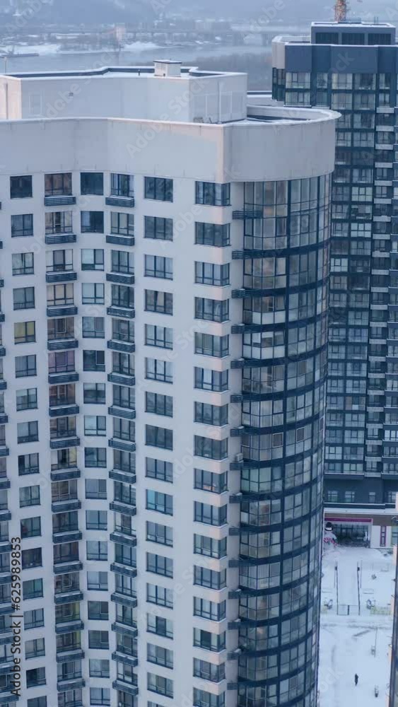 Drone view of modern office building with transparent glass windows and skyscrapers reflection in winter. Drone view of modern office building with transparent glass windows and skyscrapers reflection in winter.
