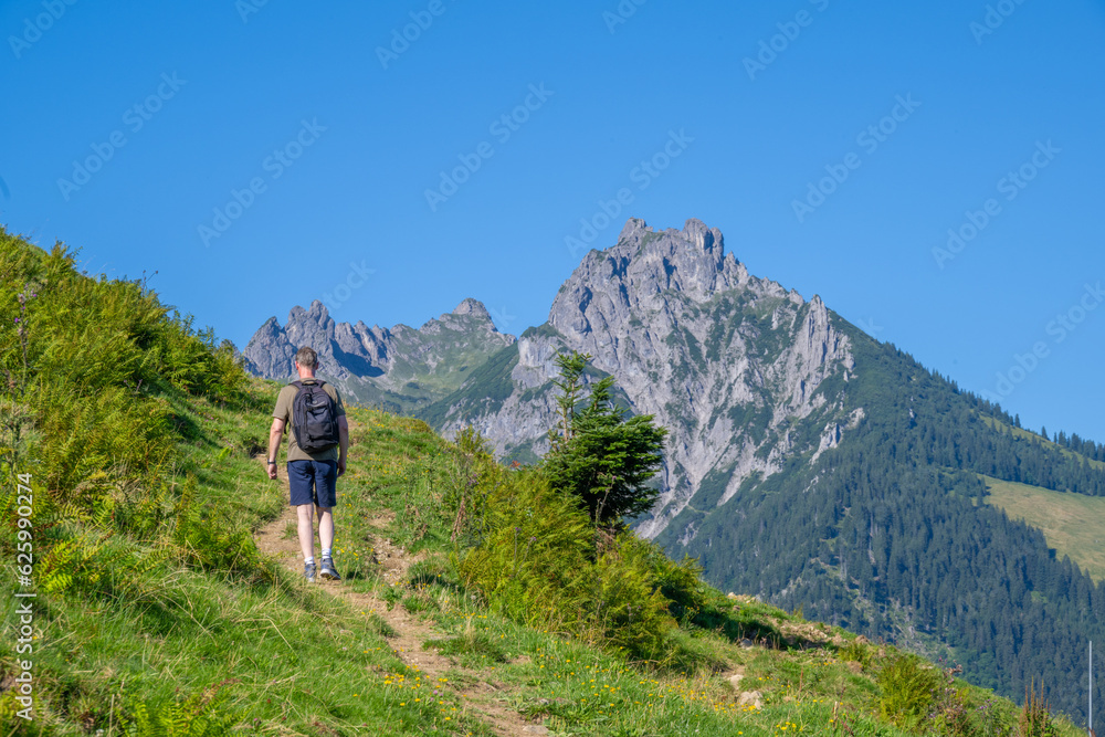 Climbing the Bazorahang with the Three Sister Mountains on the background, Walgau Valley, State of Vorarlberg, Austria