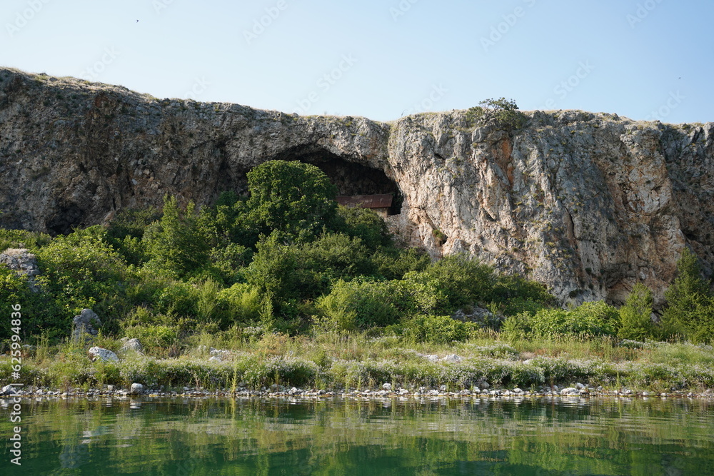 Cave at Maligrad Island (Albania, Prespa Lake) with a church (St. Mary Church) inside.