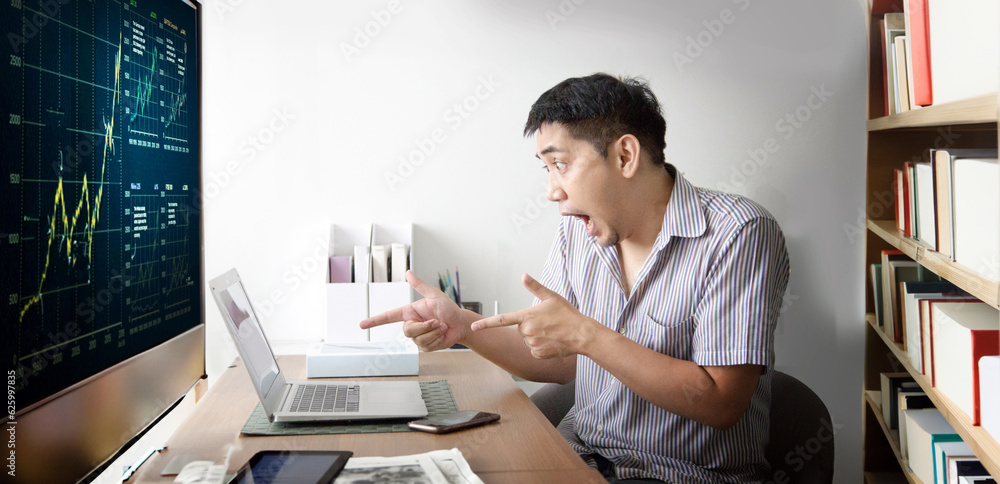 Asian man chocking action and point to laptop screenwhen win stock market on his room