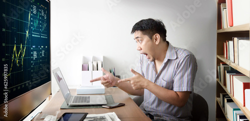 Asian man chocking action and point to laptop screenwhen win stock market on his room