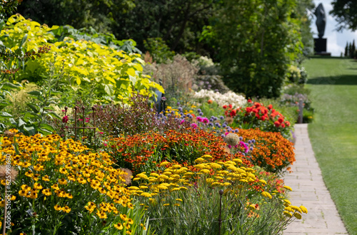 Stunning, colourful mixed flower borders at Wisley Garden, Surrey UK. The extensive flower beds have mainly perennial plants growing in them.