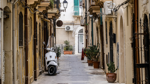 scooter standing at the empty street of old italian town