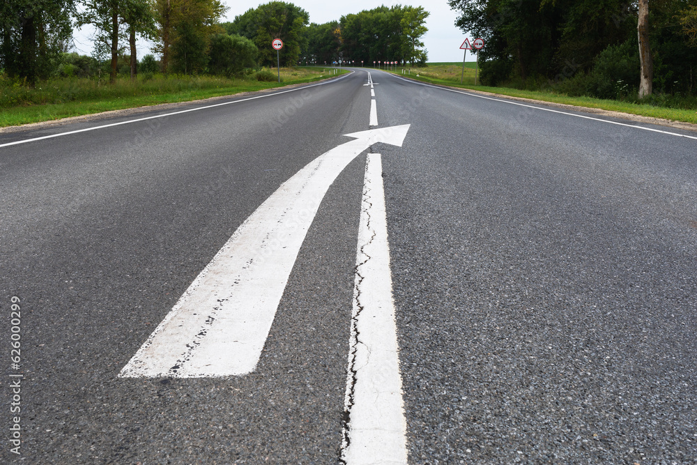 Asphalt road with markings and ending with a broken line Asphalt road with markings and ending with a broken line