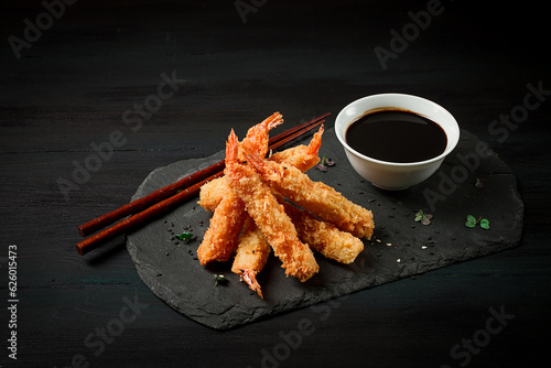 shrimp in tempura, deep-fried, on black slate, with soy sauce, horizontal, no people,