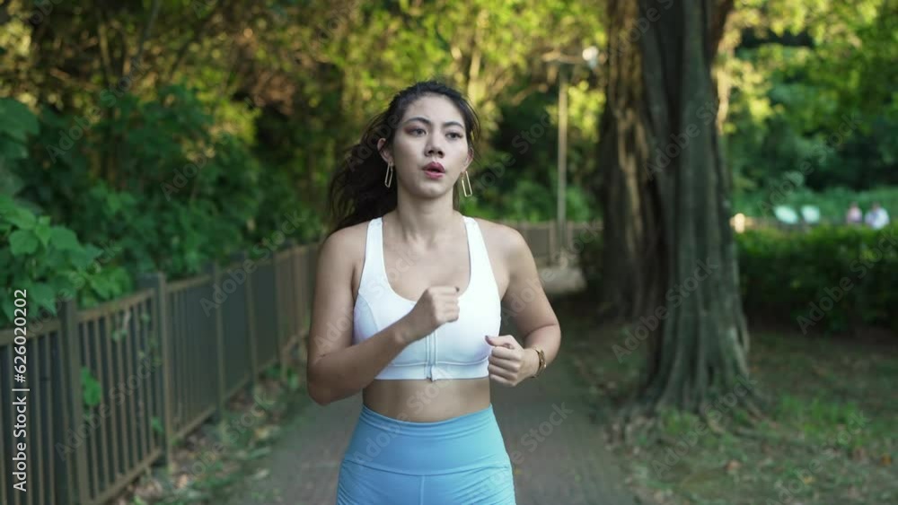 Young Asian female woman doing workout, stretching, jogging and running at a city park. Footage is part of a series of 23 different shots, including tying shoe laces, using sunglasses, resting, etc. Young Asian female woman doing workout, stretching, jogging and running at a city park. Footage is part of a series of 23 different shots, including tying shoe laces, using sunglasses, resting, etc.