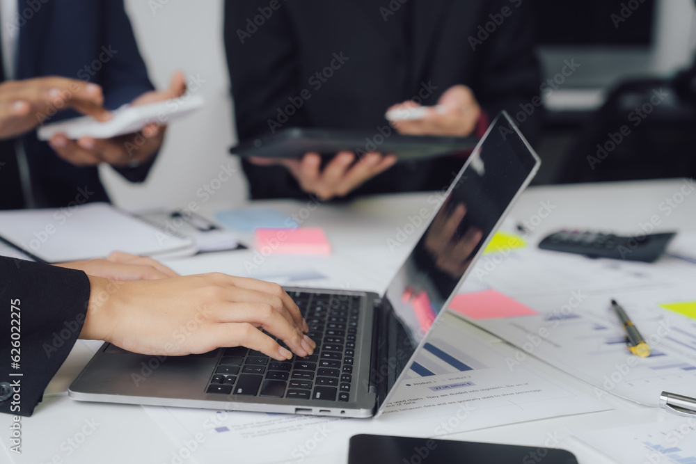 Fototapeta premium Business documents on office table with smart phone and calculator digital tablet and graph business with social network diagram and two colleagues discussing data working in office