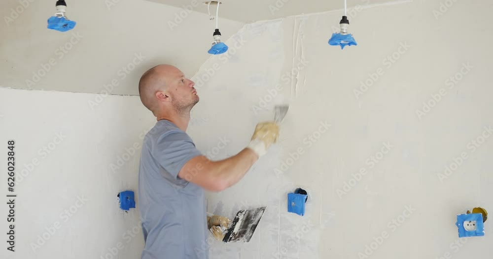 Man renovating and applying plaster on old wall. Repairing old walls