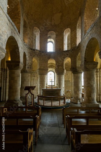 The interior of an old church with columns  windows and a pulpit in Europe