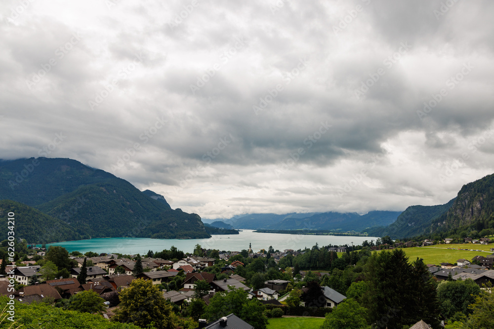 A view of Mondsee, Switzerland from an overlook with a town in the foreground and clouds above