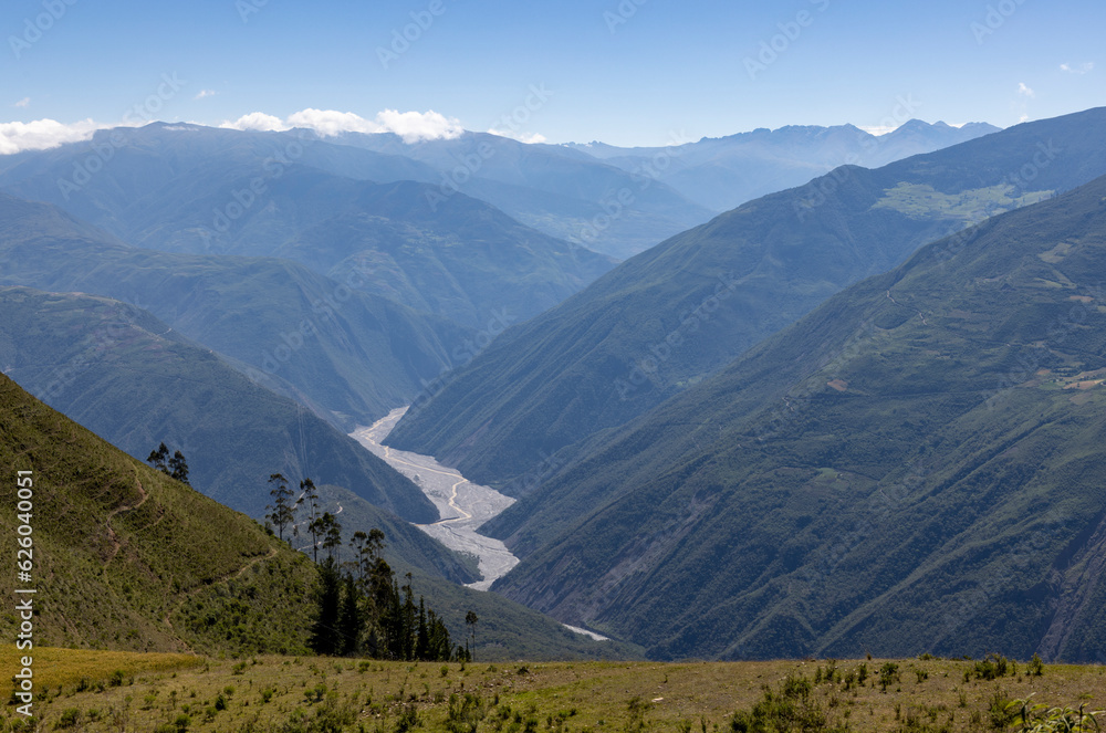 Traveling through the scenic Bolivian Andes with view into the valley where the beautiful Rio Sacambaya river flows; Exploring South America