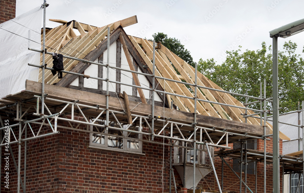 Europe, UK, England, Surrey, scaffolding on house roof renovation