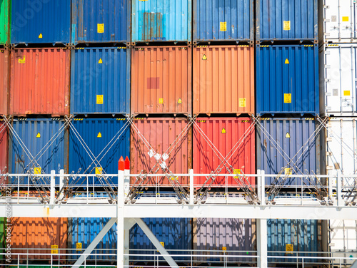 Different color containers loaded on ultra large container vessel and construction of lashing bridges for containers securing during sea passage