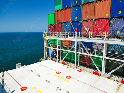 Bilde på lerret Different color containers loaded on ultra large container vessel and constructi