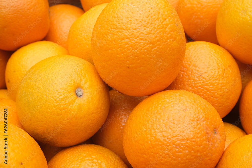background of juicy oranges freshly picked from the tree , sweet citrus fruit background of juicy oranges freshly picked from the tree , sweet citrus fruit