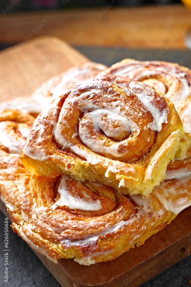 Sweet Temptation: Close-Up of Cinnamon Rolls Placed on a Wooden Surface, Tempting Your Senses in 4K Resolution