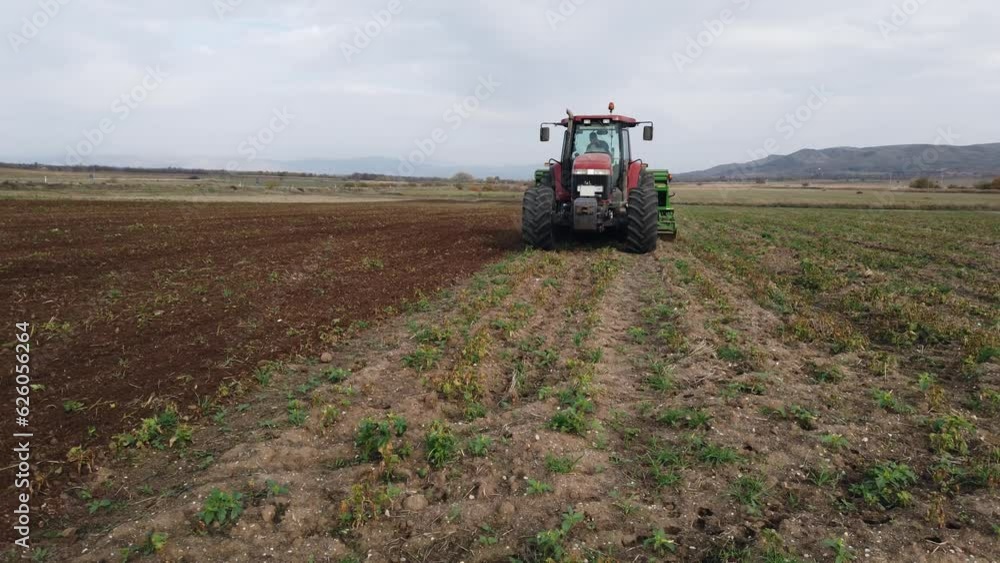 Farmer with tractor seeding - sowing crops at agricultural fields in spring, slow motion Farmer with tractor seeding - sowing crops at agricultural fields in spring, slow motion