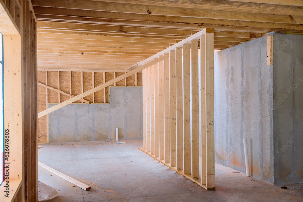 During construction is support beams built house with wooden framework frame in under construction During construction is support beams built house with wooden framework frame in under construction
