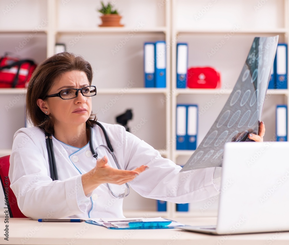 Aged female doctor radiologist in the clinic Aged female doctor radiologist in the clinic