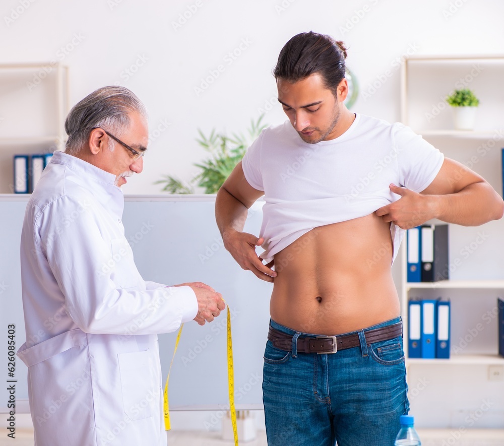 Fototapeta premium Doctor dietician giving advices to fat overweight patient
