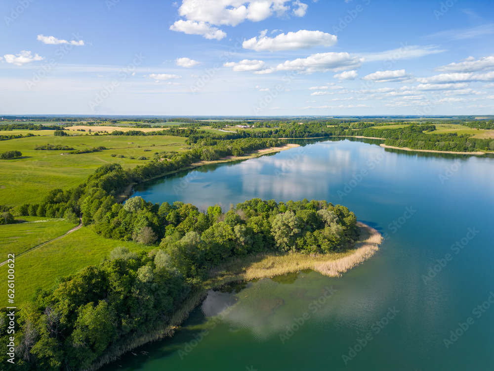 Aerial view of Lake Wuksniki - the deepest lake of the Masurian Lake District, Poland. Landscape of the Warmia region all around