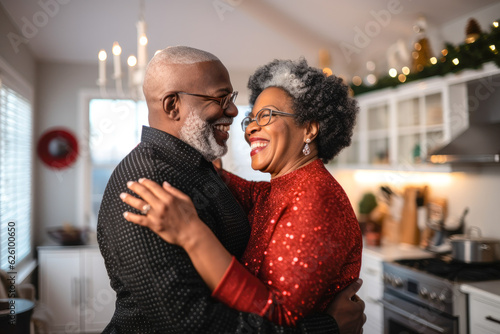 Authentic moment of an African American retired couple sharing a dance in the kitchen, an embodiment of enduring love and romance #626100650