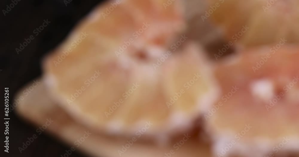focus on pieces of freshly peeled pink pomelo on the table, sweet fresh citrus pomelo on the kitchen table focus on pieces of freshly peeled pink pomelo on the table, sweet fresh citrus pomelo on the kitchen table