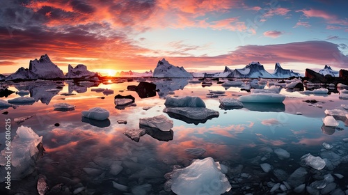 Fotografie, Obraz An awe-inspiring vista of Iceland's JÃ¶kulsÃ¡rlÃ³n Glacier Lagoon, filled with icebergs, under the pale glow of the midnight sun