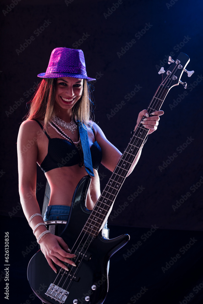 Confident bass player, skinny jeans, toned abs