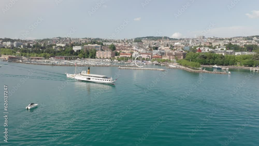 Aerial of beautiful old cruise ship with the skyline of the city Lausanne, Switzerland in the background Aerial of beautiful old cruise ship with the skyline of the city Lausanne, Switzerland in the background