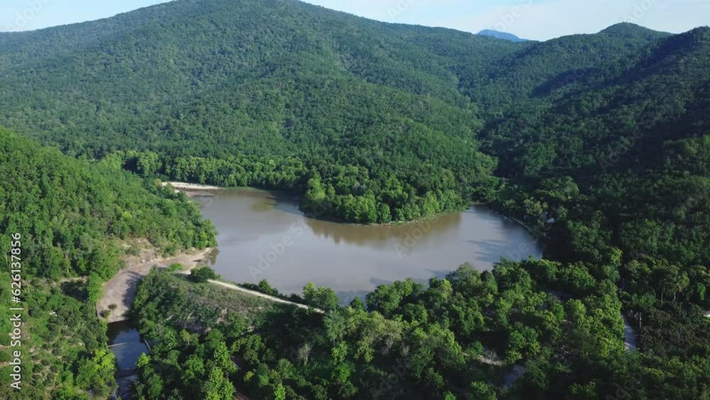 Beautiful natural scenery of river in North Asia tropical green forest with mountains in background. Aerial view of a natural river in the forest Beautiful natural scenery of river in North Asia tropical green forest with mountains in background. Aerial view of a natural river in the forest