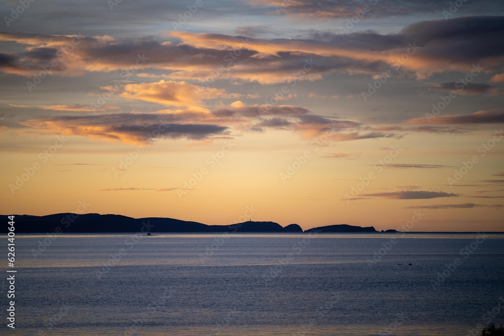 beautiful bruny island at dawn with pink clouds and the ocean below