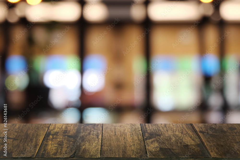 Empty dark wooden table in front of abstract blurred boken bankground of restaurant. Can used for display or montage your products. Mock up for space.